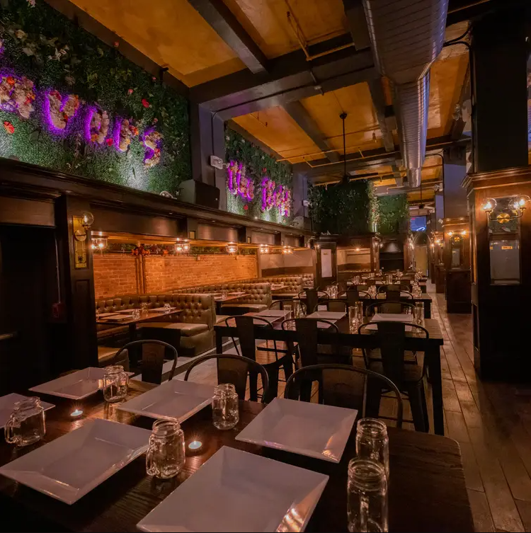 Interior of The Dean NYC party venue with spacious dance floor, ambient lighting, and VIP seating.