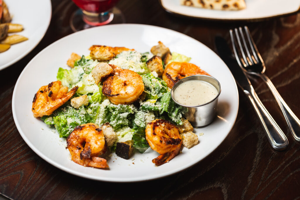 Fresh Caesar salad with shrimp served at The Dean NYC, ideal for corporate events in the best event space NYC for corporate events.